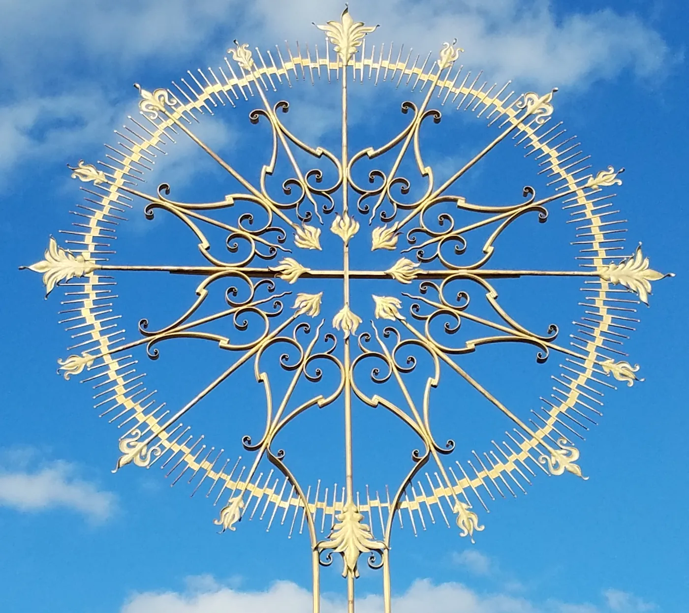 The ornate gold Resurrection Cross at Our Lady of the Rosary Cemetery
