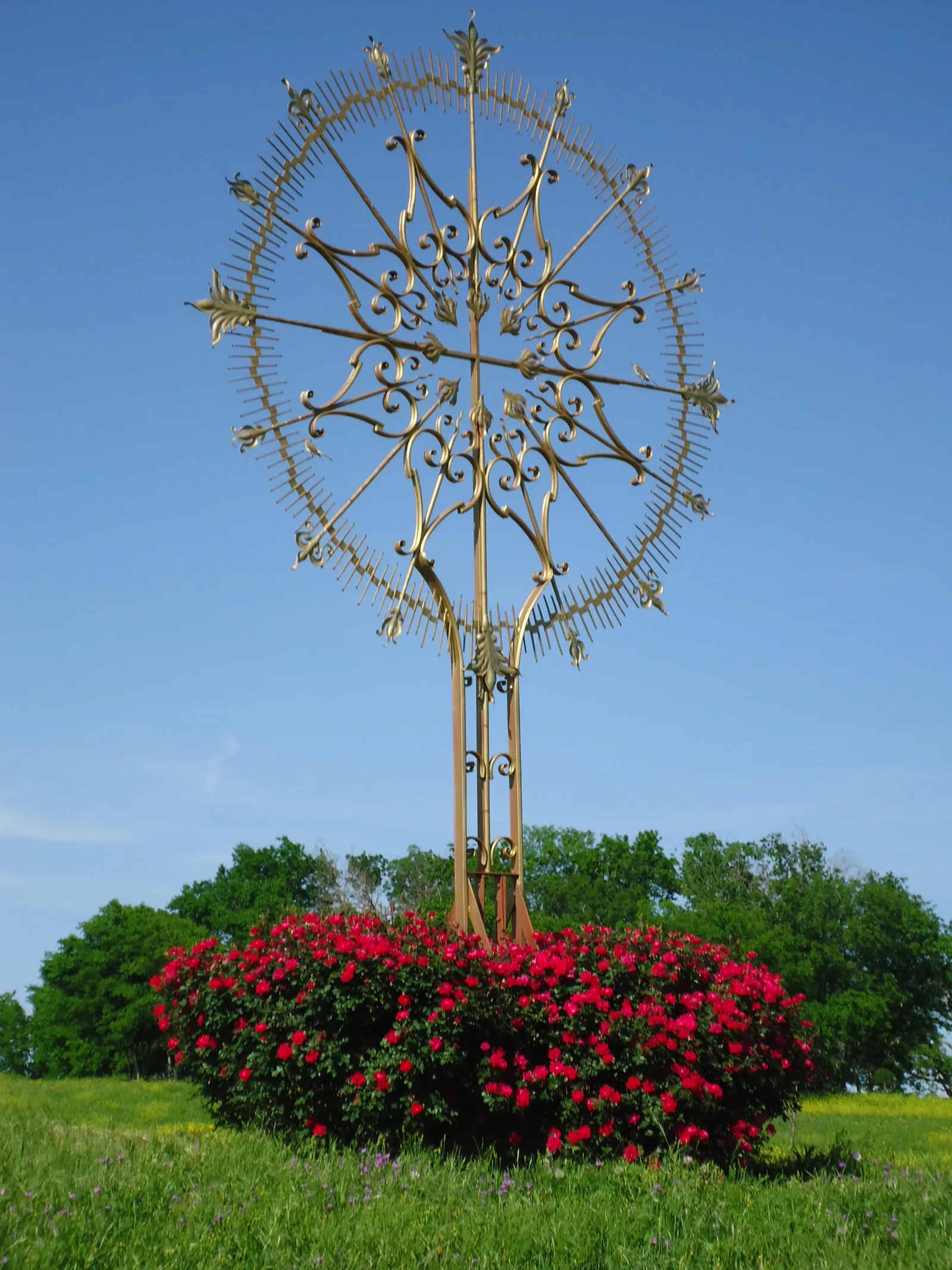 The Resurrection Cross surrounded by roses at Our Lady of the Rosary Cemetery